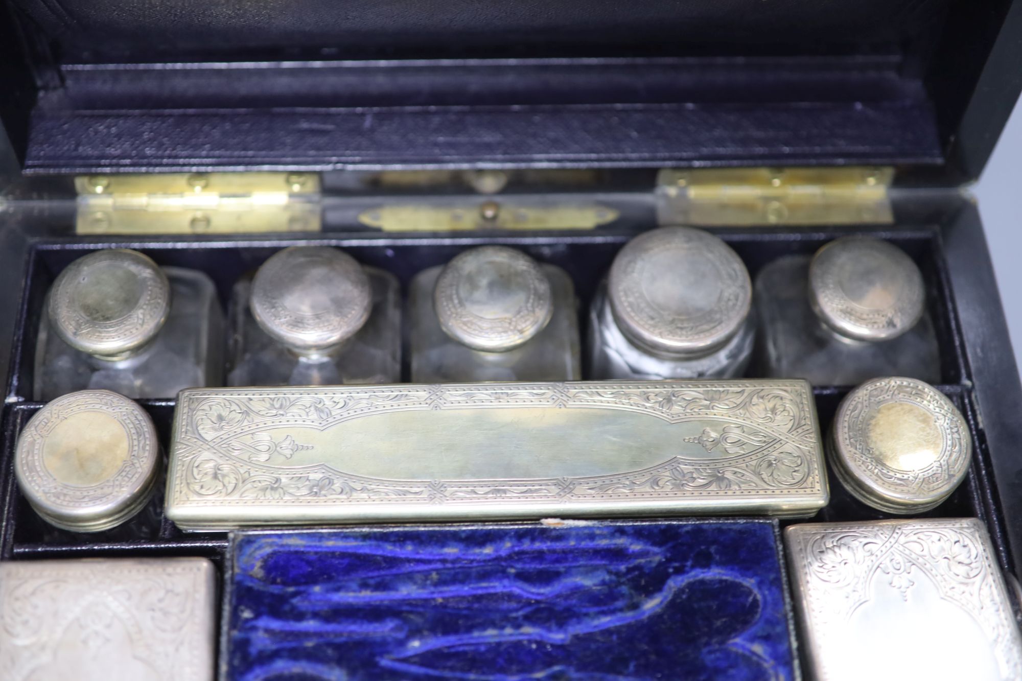 A Victorian coromandel toilet box with silver mounted toilet jars(four lids unmarked), retailed by Asprey & Co,
